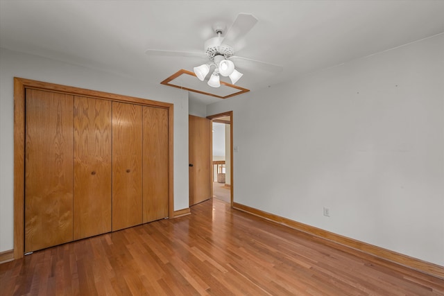 unfurnished bedroom with light hardwood / wood-style flooring, a closet, and ceiling fan