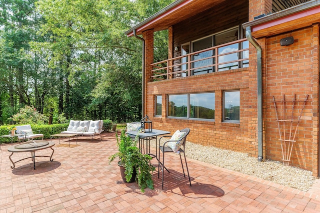 view of patio featuring outdoor lounge area and a balcony