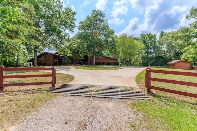 view of gate featuring a lawn