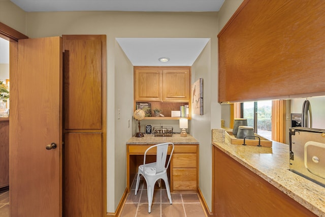 kitchen featuring light stone counters and light tile patterned flooring