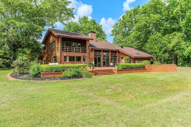 rear view of house with a yard