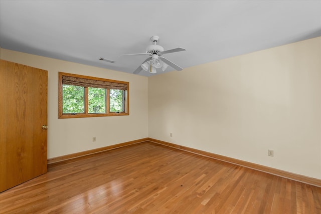 spare room featuring hardwood / wood-style flooring and ceiling fan