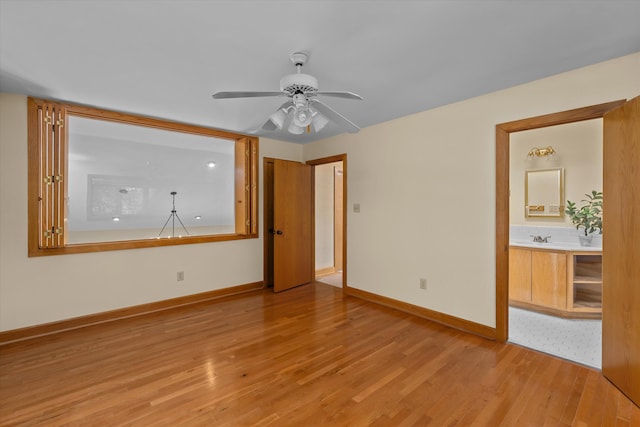 interior space featuring ceiling fan, light hardwood / wood-style flooring, and sink