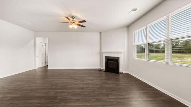 unfurnished living room featuring ceiling fan and dark hardwood / wood-style floors