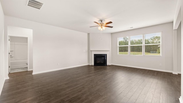 unfurnished living room featuring ceiling fan and dark hardwood / wood-style floors