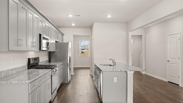 kitchen featuring gray cabinetry, appliances with stainless steel finishes, sink, and light stone counters