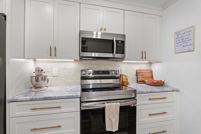 2219 Vireo Dr, North Augusta, SC 29841 - kitchen featuring appliances with stainless steel finishes, tasteful backsplash, white cabinets, and light stone counters