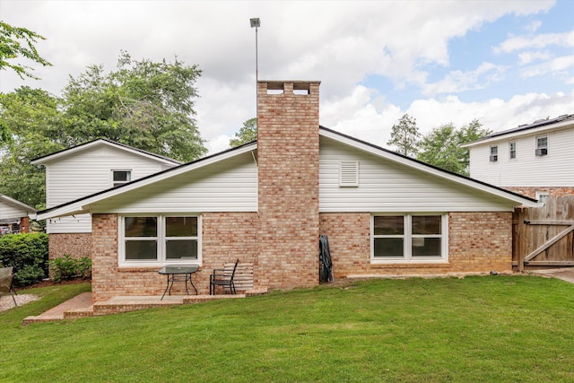 2219 Vireo Dr, North Augusta, SC 29841 - back of property with brick siding, a chimney, and a patio