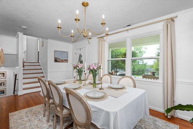 2219 Vireo Dr, North Augusta, SC 29841 - dining area featuring a chandelier, wood finished floors, and stairway