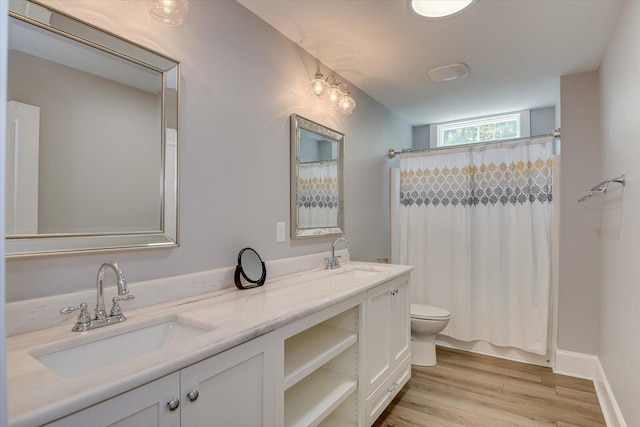 bathroom with hardwood / wood-style floors, vanity, and toilet