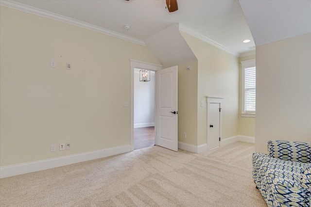 sitting room featuring ceiling fan, crown molding, and light carpet