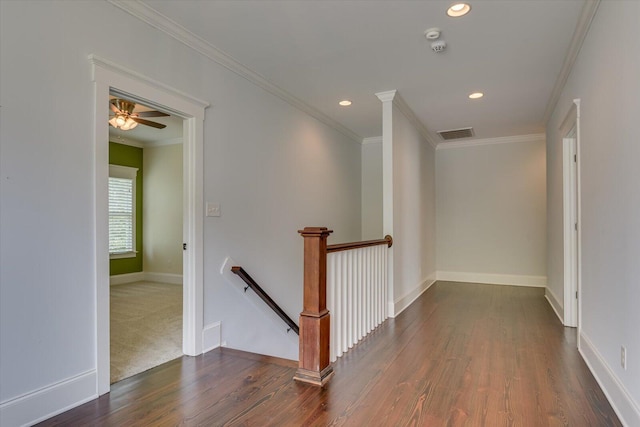 corridor with dark hardwood / wood-style flooring and ornamental molding