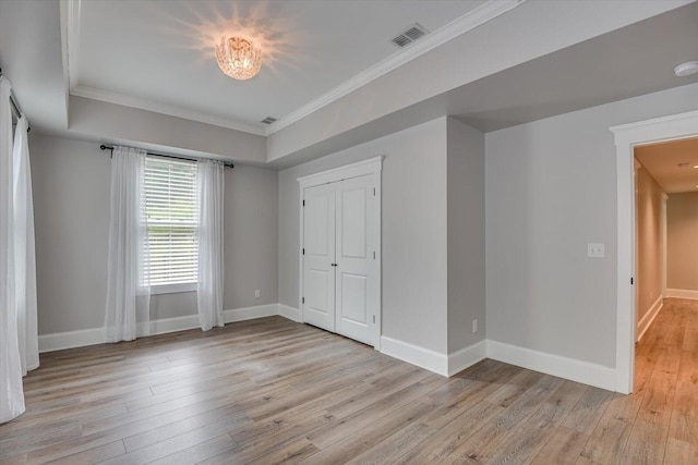 spare room with light hardwood / wood-style flooring and crown molding