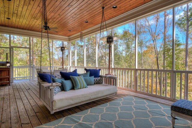 sunroom with ceiling fan and wood ceiling