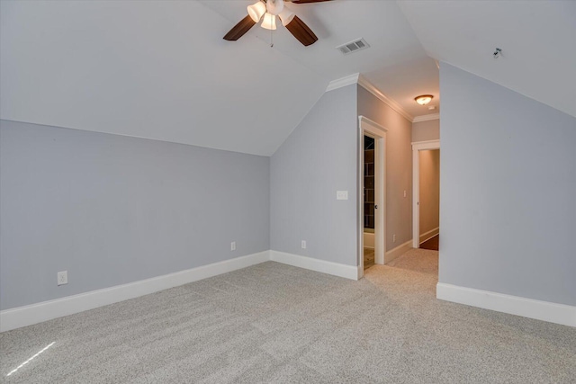 additional living space with light colored carpet, vaulted ceiling, and ceiling fan