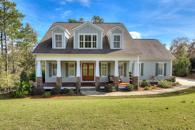 new england style home with french doors, a front lawn, and a porch