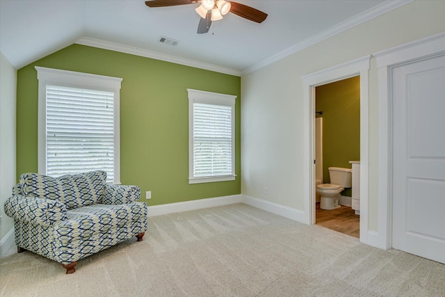 sitting room featuring a healthy amount of sunlight, light colored carpet, lofted ceiling, and crown molding