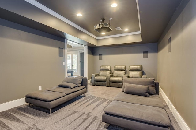 cinema featuring a tray ceiling, french doors, carpet, and ornamental molding