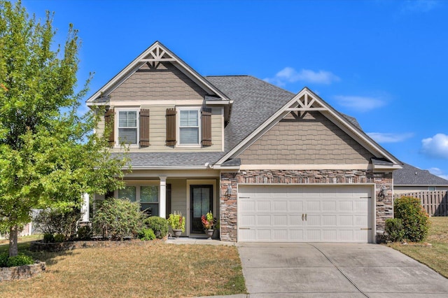 craftsman-style home featuring a garage and a front yard