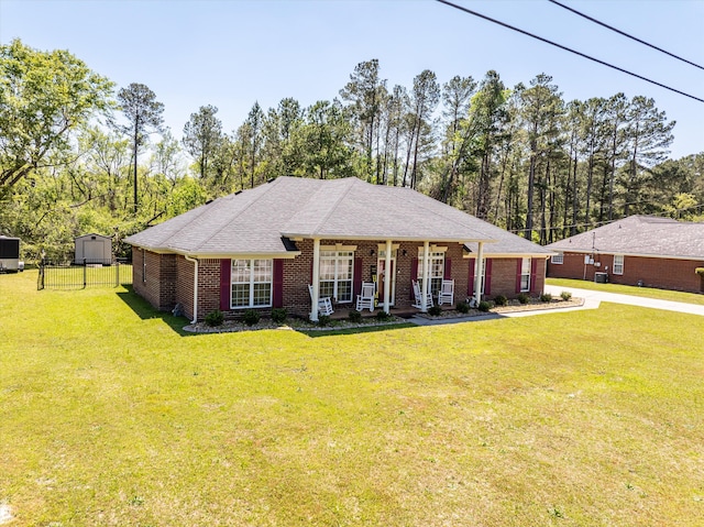2795 Davis Mill Rd, Hephzibah, GA 30815 - ranch-style home with fence, roof with shingles, covered porch, brick siding, and a front yard