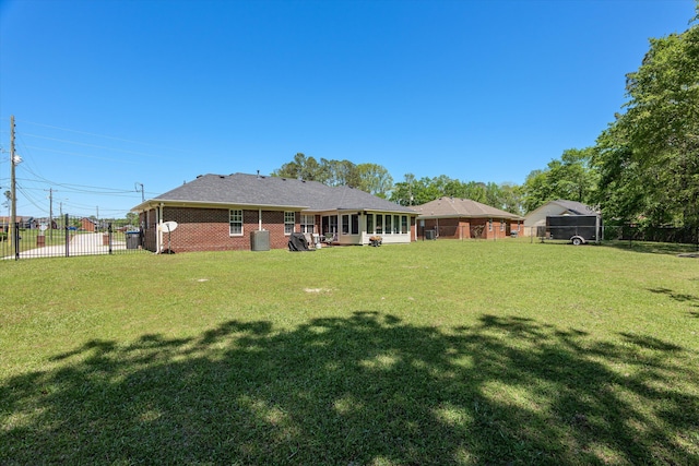 2795 Davis Mill Rd, Hephzibah, GA 30815 - rear view of house with fence, a lawn, and brick siding