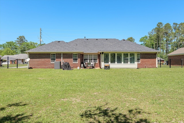 2795 Davis Mill Rd, Hephzibah, GA 30815 - rear view of property featuring brick siding, a lawn, and a fenced backyard