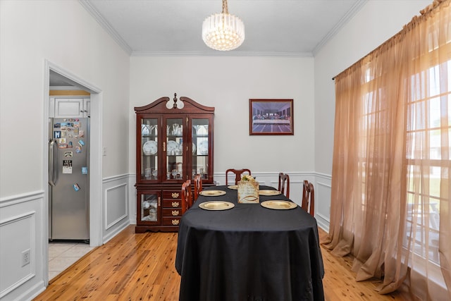 2795 Davis Mill Rd, Hephzibah, GA 30815 - dining room featuring an inviting chandelier, ornamental molding, a wainscoted wall, and light wood-type flooring