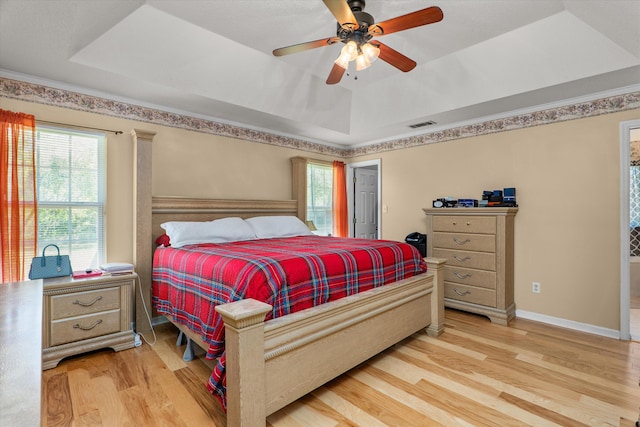 2795 Davis Mill Rd, Hephzibah, GA 30815 - bedroom with visible vents, wood finished floors, a tray ceiling, and ceiling fan