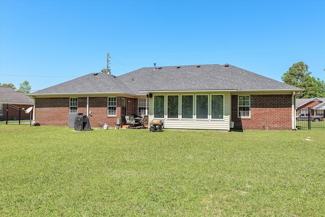 2795 Davis Mill Rd, Hephzibah, GA 30815 - back of property with a lawn, fence, a shingled roof, and brick siding