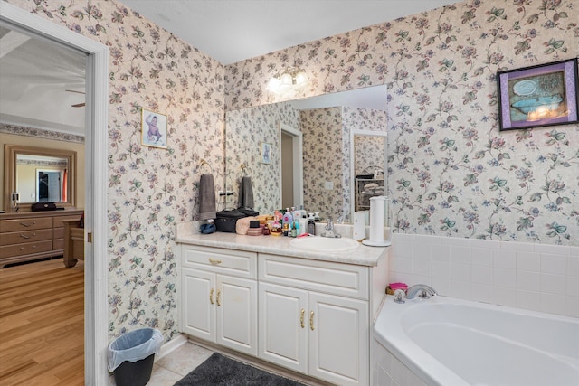 2795 Davis Mill Rd, Hephzibah, GA 30815 - full bathroom featuring baseboards, wallpapered walls, wood finished floors, a garden tub, and vanity