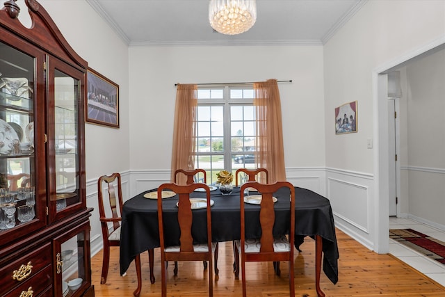 2795 Davis Mill Rd, Hephzibah, GA 30815 - dining space with light wood-type flooring, a wainscoted wall, a chandelier, and ornamental molding