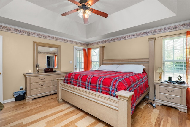 2795 Davis Mill Rd, Hephzibah, GA 30815 - bedroom with a ceiling fan, a tray ceiling, light wood-style floors, and multiple windows