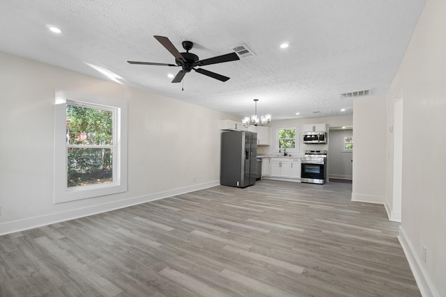 5 Elm St, Beech Island, SC 29841 - unfurnished living room with a chandelier, ceiling fan, light wood-type flooring, a textured ceiling, and recessed lighting