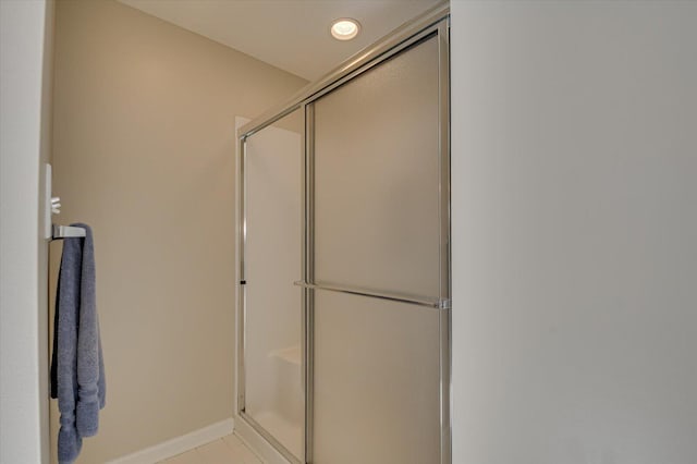 bathroom featuring tile patterned floors and an enclosed shower