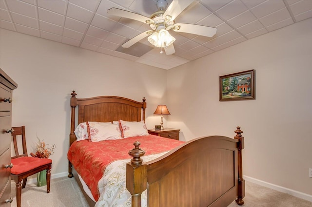 carpeted bedroom featuring a paneled ceiling and ceiling fan