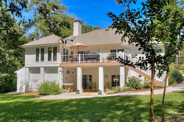 back of house with a wooden deck and a yard