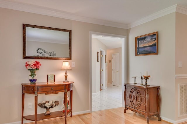 hall featuring light hardwood / wood-style floors and crown molding