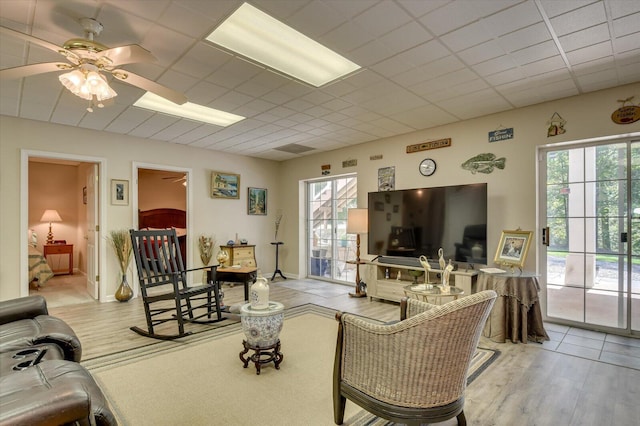 living room featuring ceiling fan and light hardwood / wood-style flooring