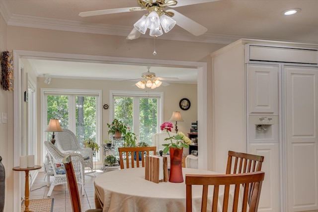 tiled dining space featuring ornamental molding