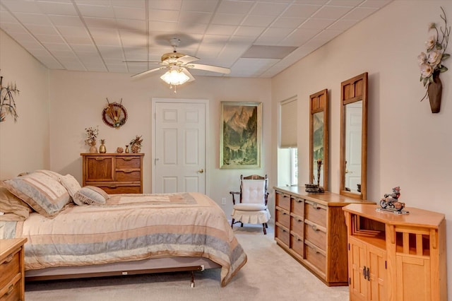 bedroom with ceiling fan and light carpet