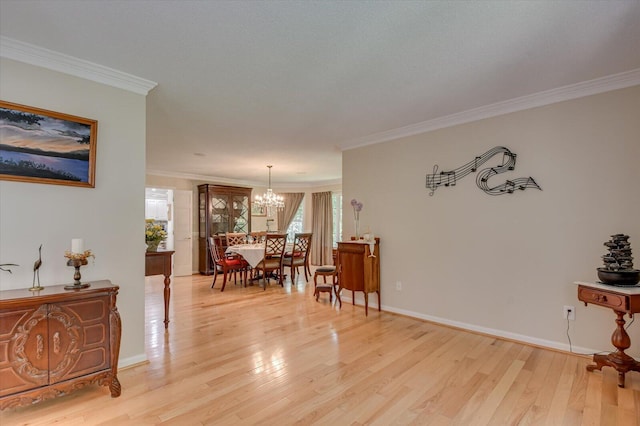 interior space featuring light hardwood / wood-style floors, crown molding, and an inviting chandelier