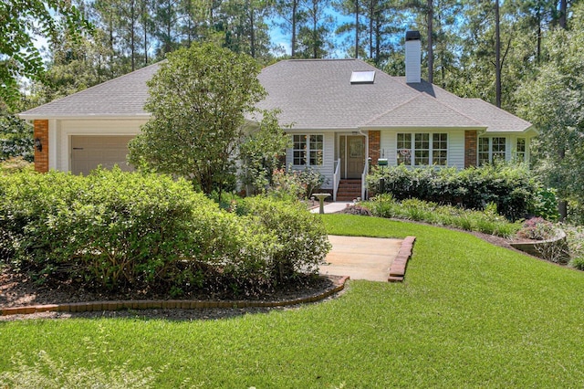 ranch-style house featuring a garage and a front lawn