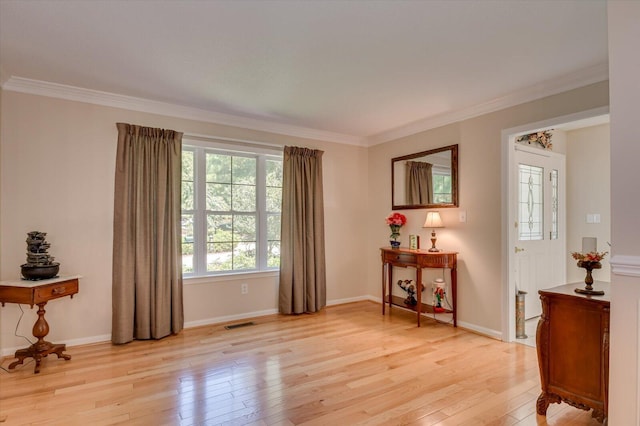 interior space featuring light hardwood / wood-style floors and crown molding