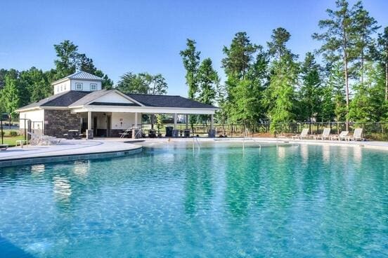 pool featuring a patio area and fence