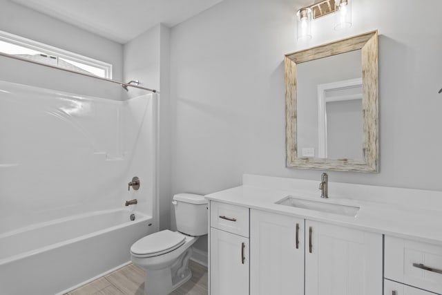 full bathroom with vanity, toilet, washtub / shower combination, and wood-type flooring