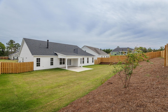 back of house with a lawn and a patio area