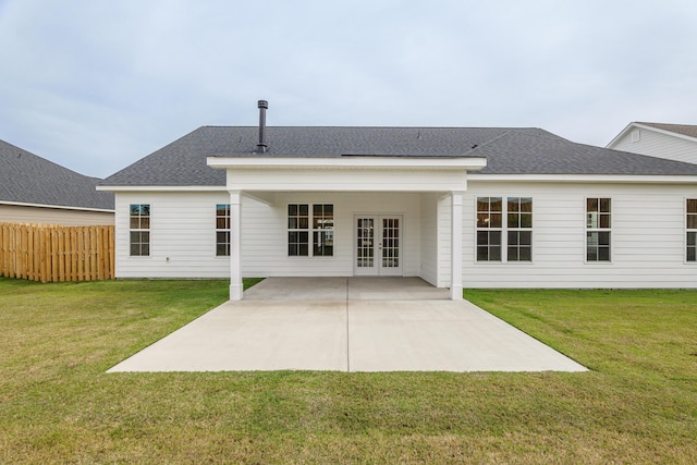 rear view of house with a yard, french doors, and a patio