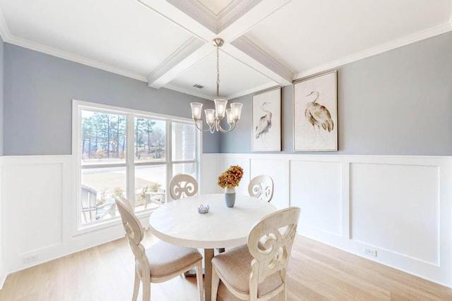 dining area with light hardwood / wood-style flooring, an inviting chandelier, coffered ceiling, ornamental molding, and beamed ceiling