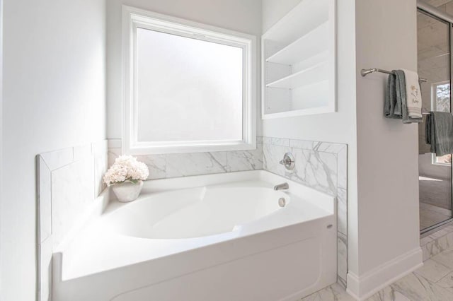 bathroom with a tub to relax in