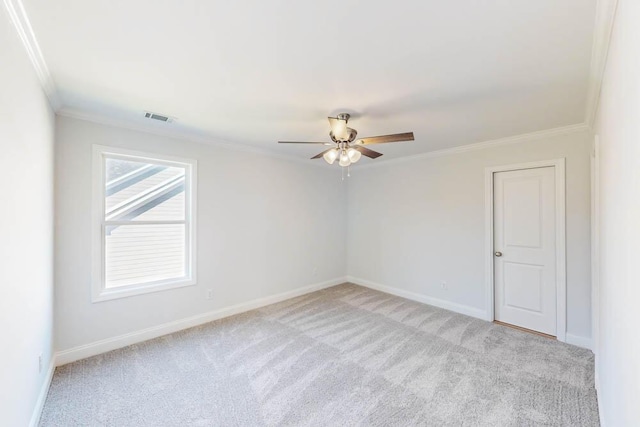 carpeted empty room featuring ornamental molding and ceiling fan